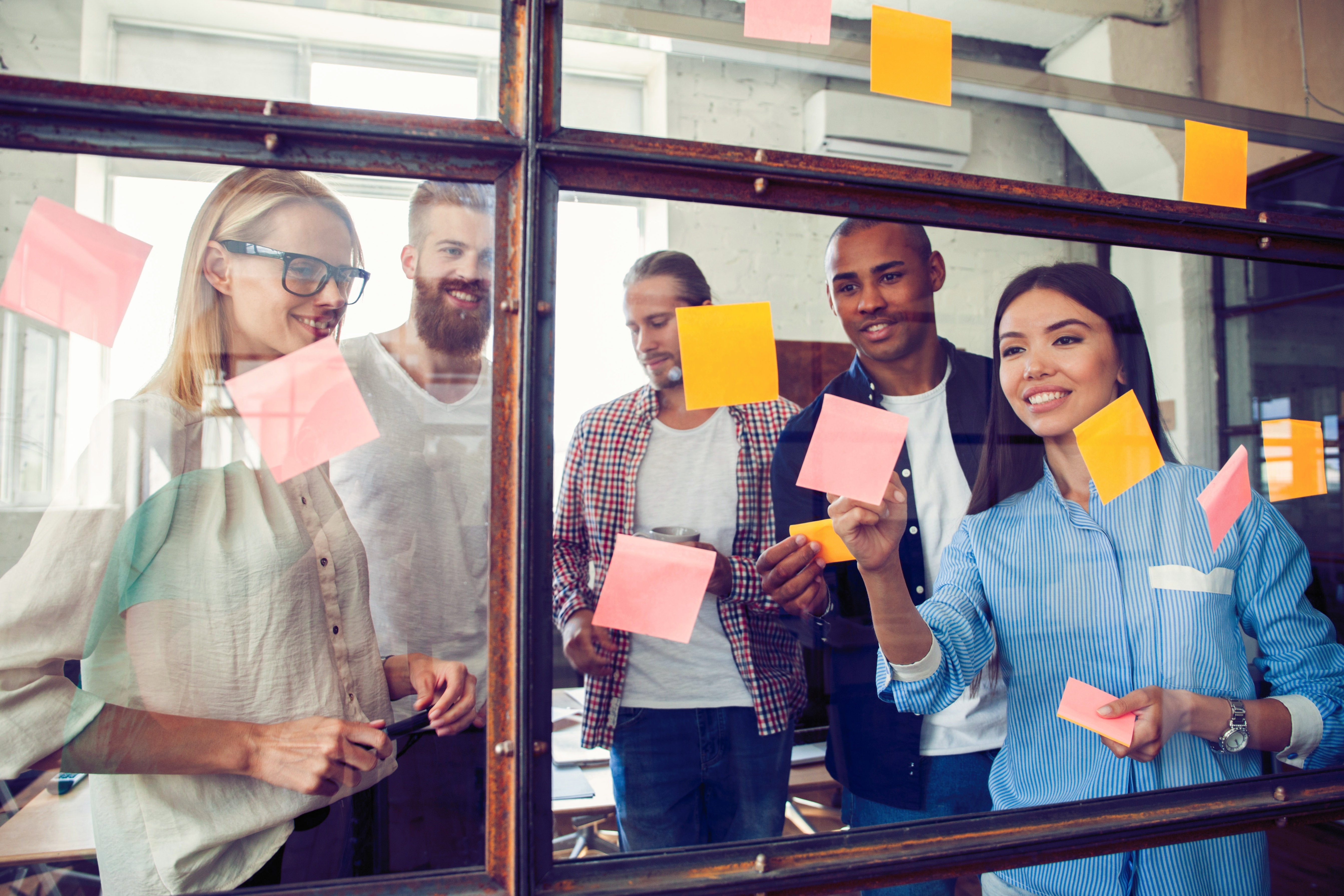 Coworkers brainstorming with sticky notes